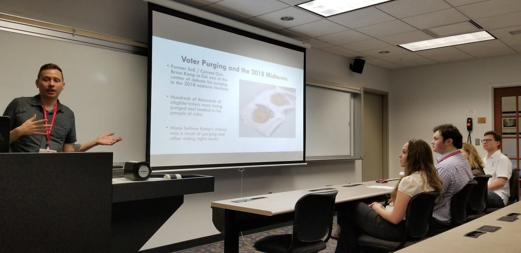 University student giving a presentation on Voter Purging